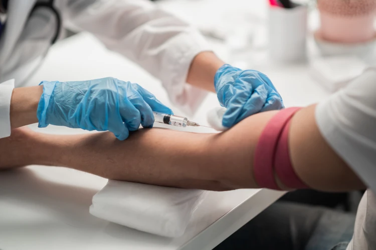 A nurse in the lab takes a blood test.