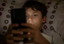 A boy browsing on his smartphone.