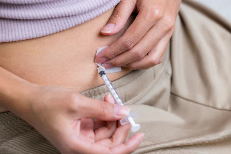 Woman injecting on her belly.
