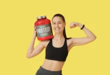 Woman with jar of protein powder.