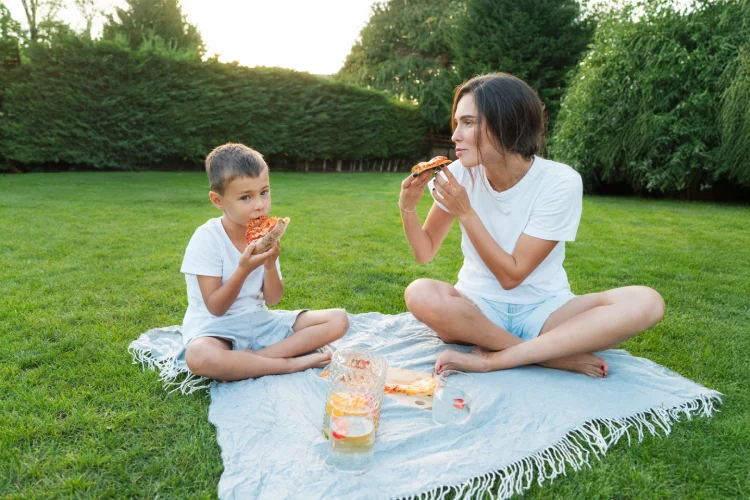 Mother and son enjoying early dinner.