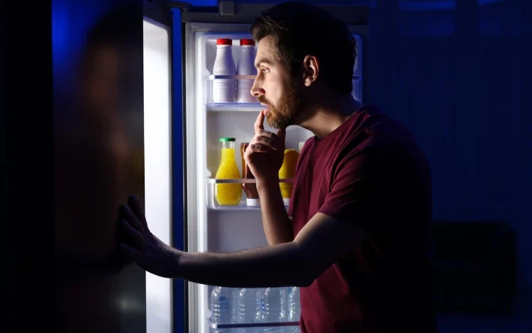 Man looking for food late at night.
